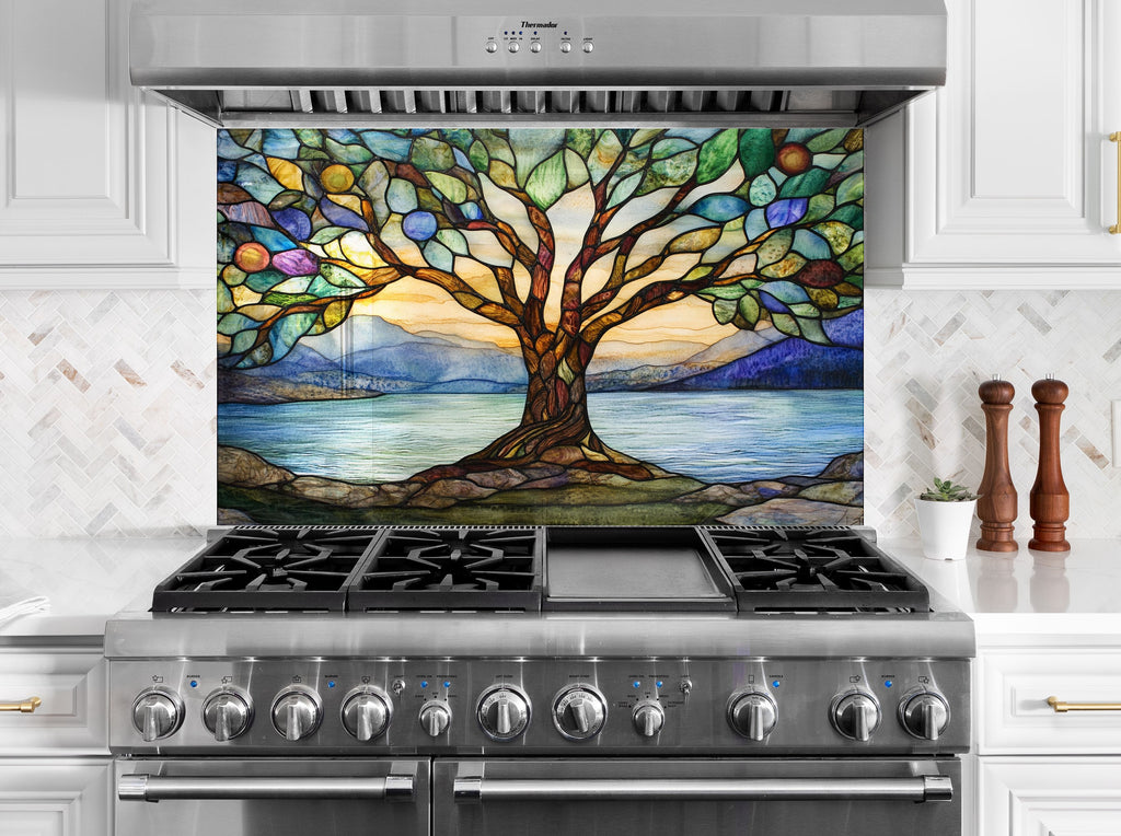Backsplash glass art featuring a colorful tree of life over serene lakeside sunset – ideal for artistic kitchen spaces.

