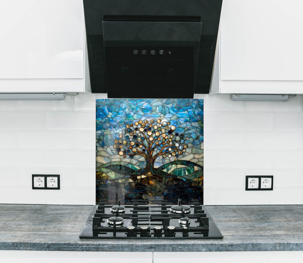 Art glass backsplash featuring a luminous mosaic tree with flowing hill pattern.

