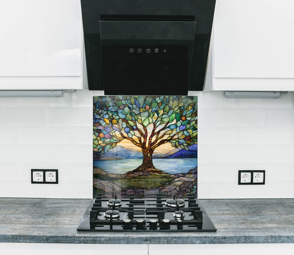 Vibrant stained glass tree backsplash with nature-inspired lake and mountain scene – a stunning kitchen centerpiece.


